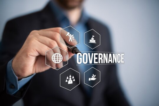 Uomo in giacca blu che punta il focus sulla parola governance, circondata da icone rappresentative: globo, figure umane, crescita e leadership.